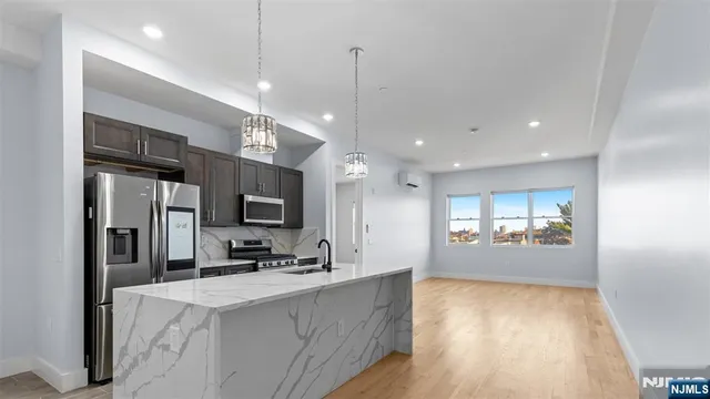 a view of kitchen with center island and stainless steel appliances