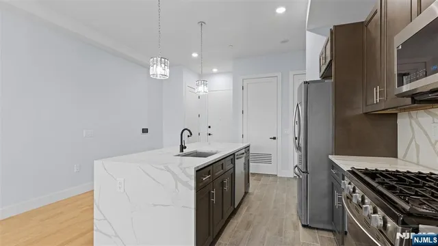 a kitchen with a sink stove and refrigerator
