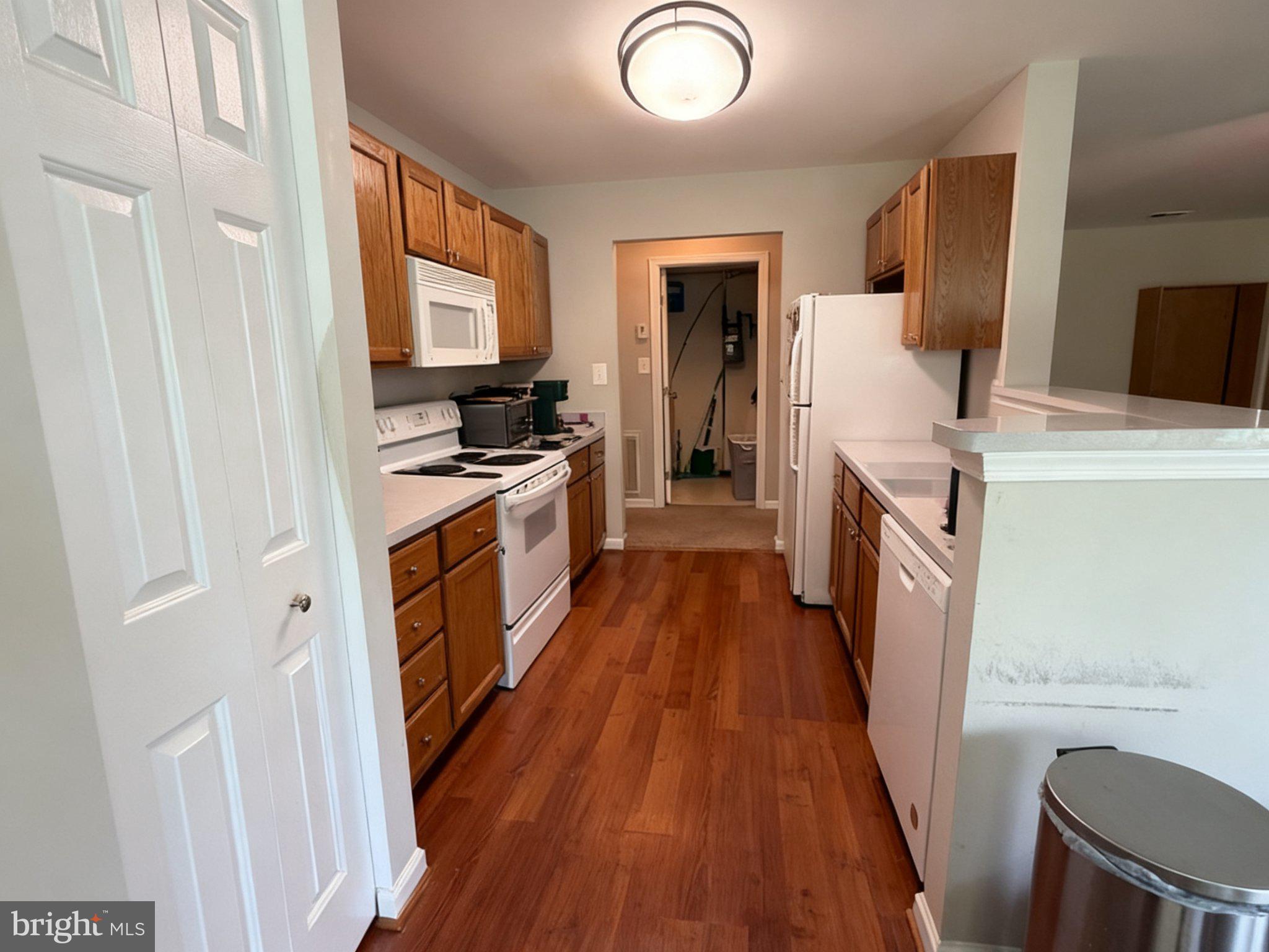 25910 Ridge Manor Drive, Unit G Damascus, MD 20872 - Photo 6 of 31 Maple Cabinets with Light Colored Counter Tops