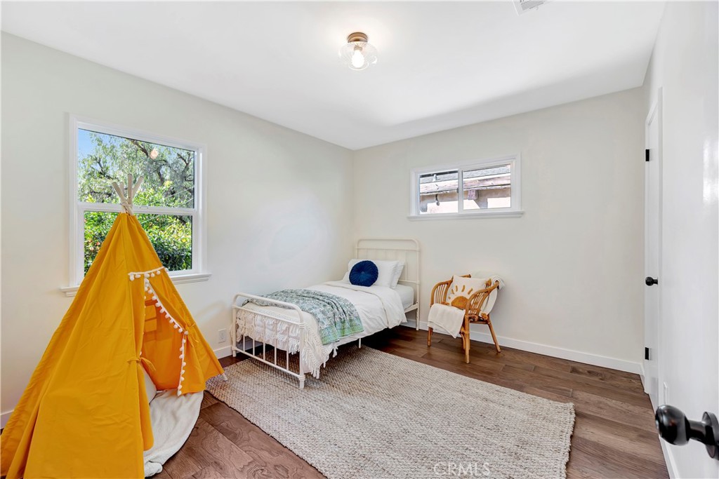 68 Laurel Drive Altadena, CA 91001 - Photo 35 of 59 a bedroom with a bed and a wooden floor