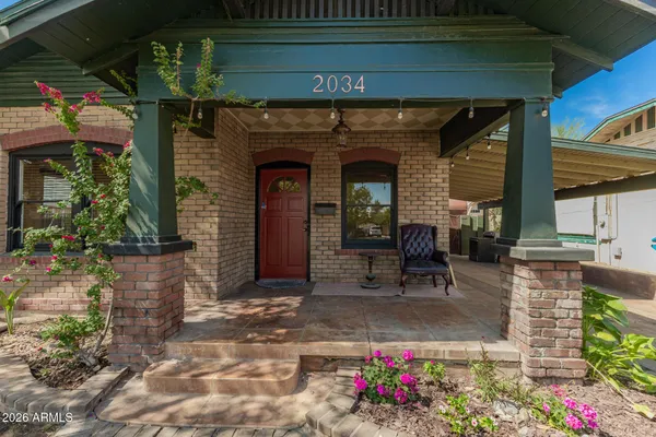a front view of a house with outdoor seating and plants