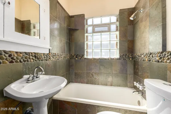 a white bath tub sitting next to a white sink