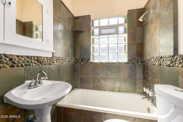 a white bath tub sitting next to a white sink