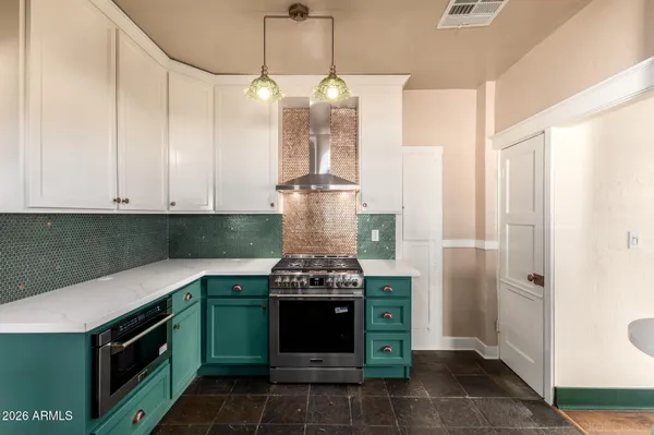 a kitchen with a stove and a chandelier