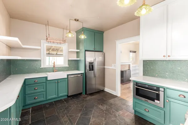a kitchen with a refrigerator and a sink