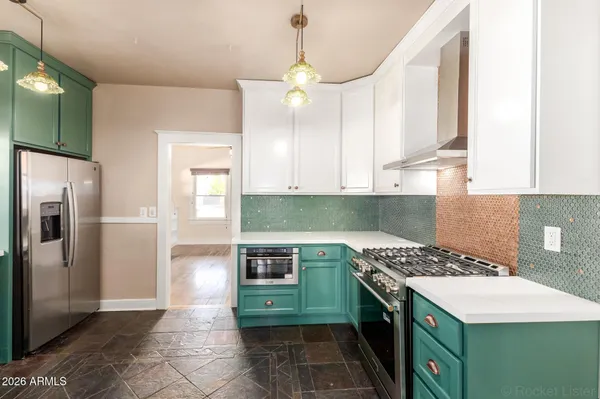 a kitchen with a stove and a refrigerator