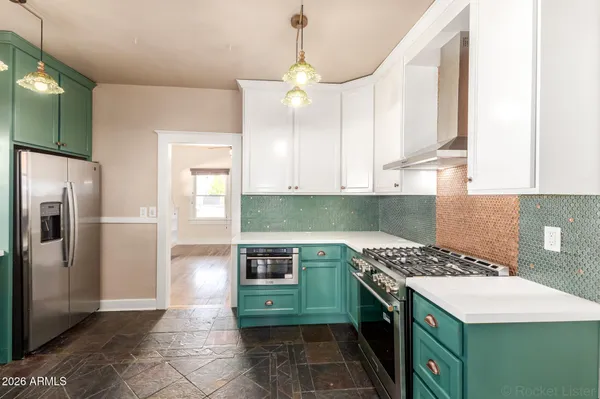 a kitchen with a stove and a refrigerator