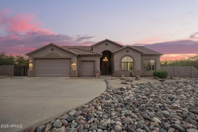 a front view of a house with a garden