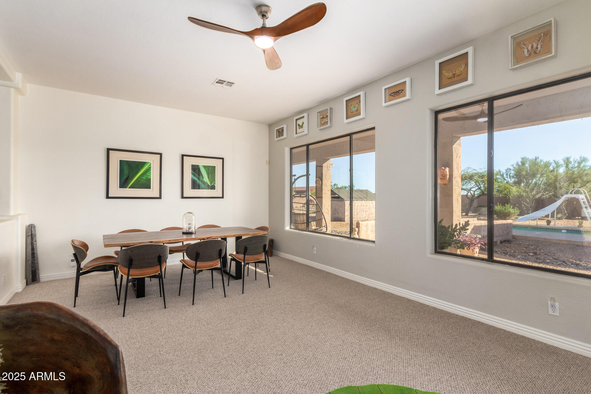 105 East Tanya Road Phoenix, AZ 85086 - Photo 24 of 63 a living room with furniture a dining table and a large window
