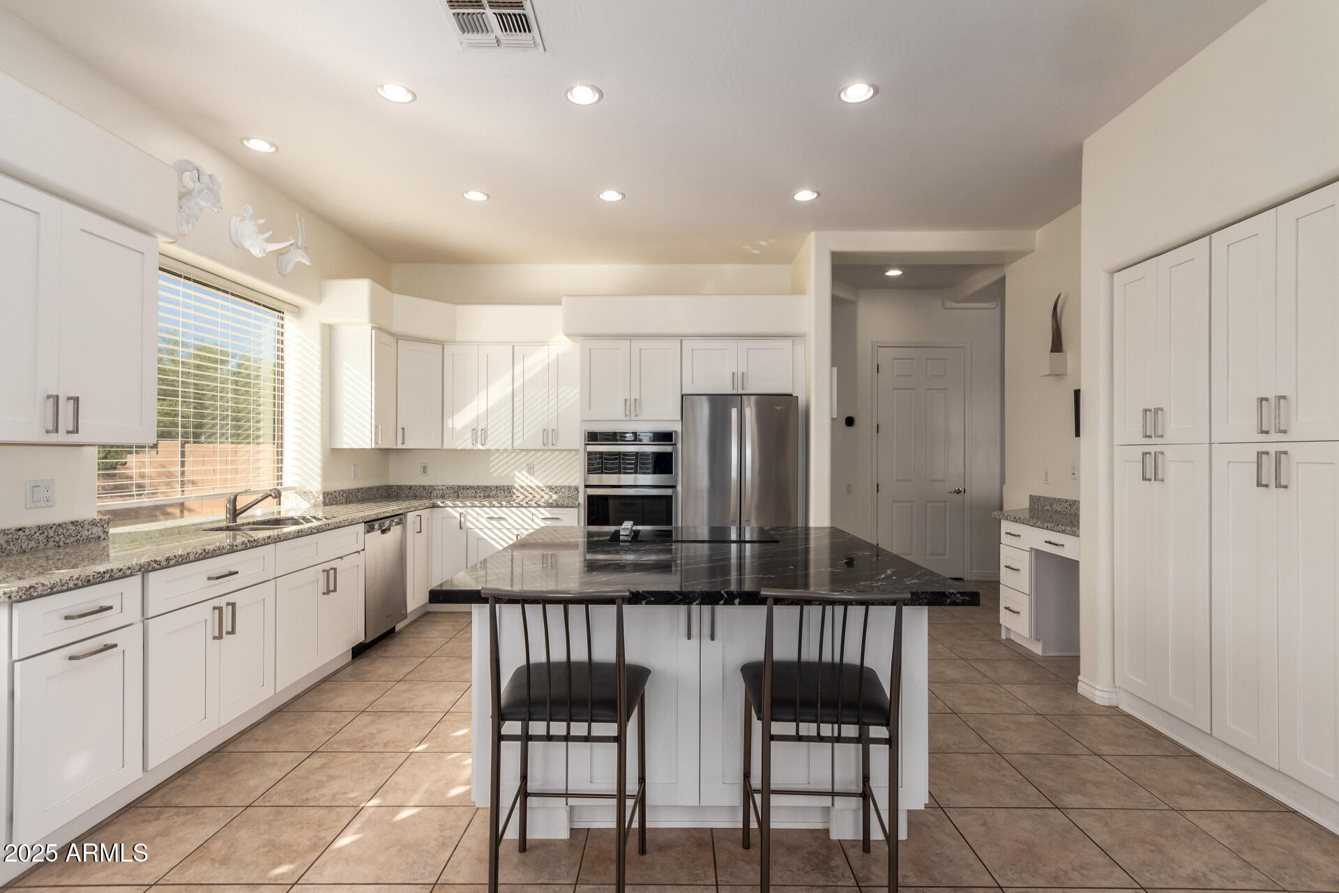 105 East Tanya Road Phoenix, AZ 85086 - Photo 28 of 63 a kitchen with stainless steel appliances granite countertop a stove and a refrigerator