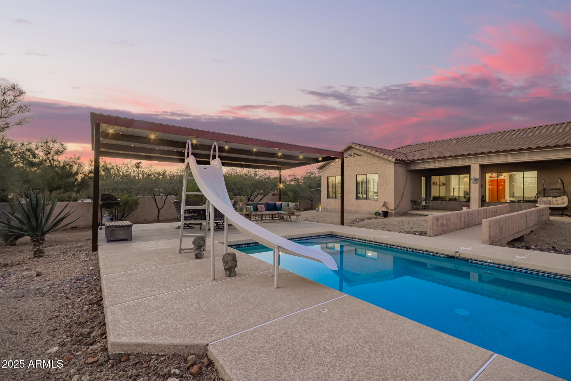 105 East Tanya Road Phoenix, AZ 85086 - Photo 50 of 63 a view of a house with swimming pool and sitting area
