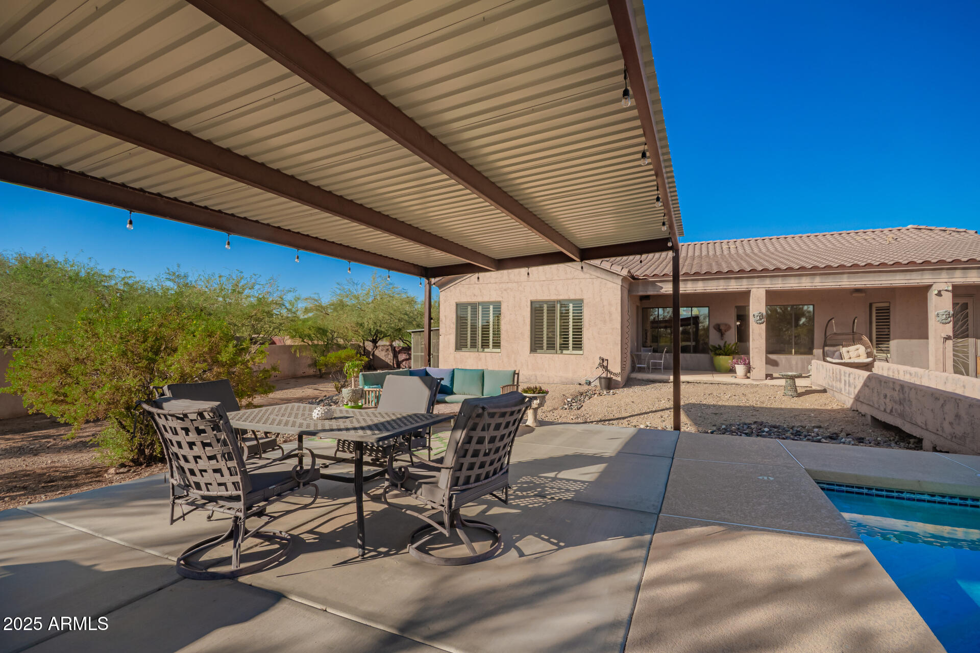 105 East Tanya Road Phoenix, AZ 85086 - Photo 57 of 63 a view of a patio with table and chairs with wooden floor and fence