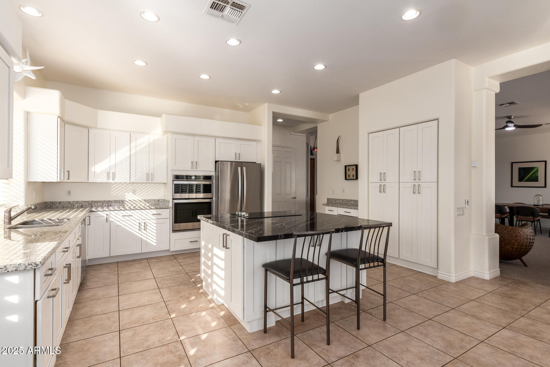 105 East Tanya Road Phoenix, AZ 85086 - Photo 8 of 63 a kitchen with stainless steel appliances kitchen island granite countertop a refrigerator and cabinets