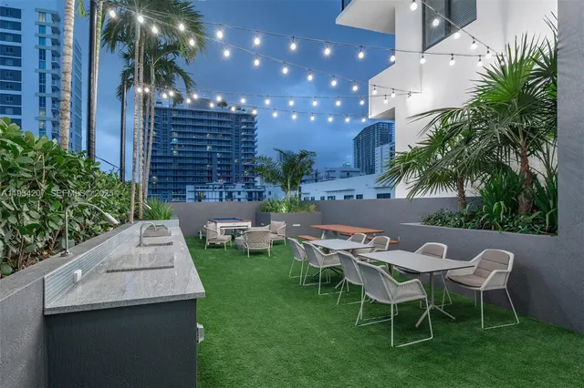 a view of a patio with couches table and chairs and potted plants