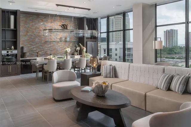 a living room with furniture and a floor to ceiling window