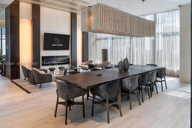 a view of a a dining room with furniture window and wooden floor