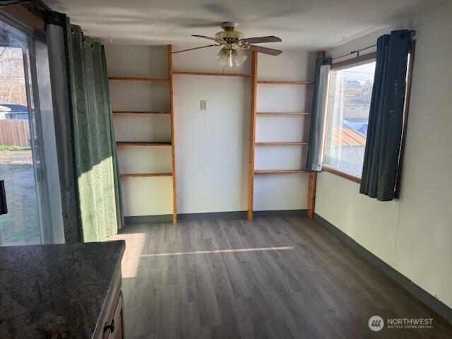 1206 Sunset Street Southeast Ephrata, WA 98823 - Photo 8 of 11 a view of empty room with wooden floor and fan
