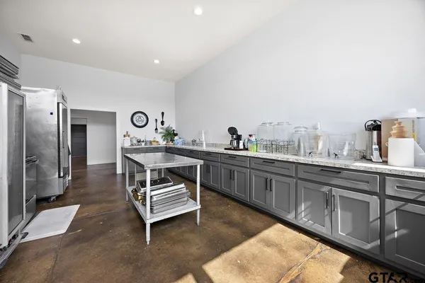 a kitchen with stainless steel appliances a stove a sink and a refrigerator
