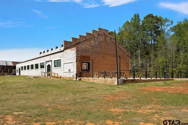 a big house with a big yard and large trees