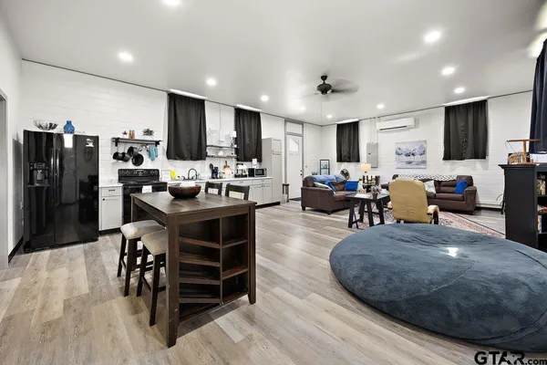 a living room with furniture a kitchen and kitchen view