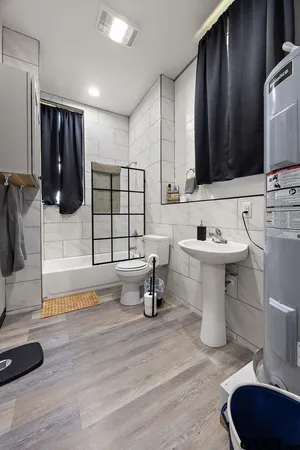 a bathroom with a sink toilet and mirror