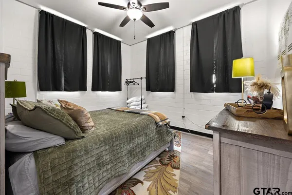 a bedroom with a bed lamps and table