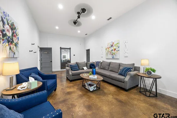 a living room with furniture and a lamp