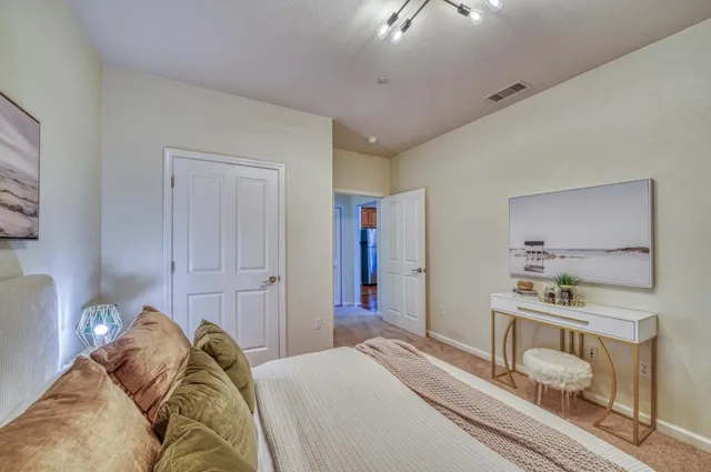 a bedroom with a bed and a dresser