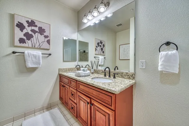 a bathroom with a sink a vanity and a mirror