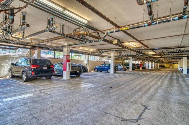 a view of parking garage with cars parked