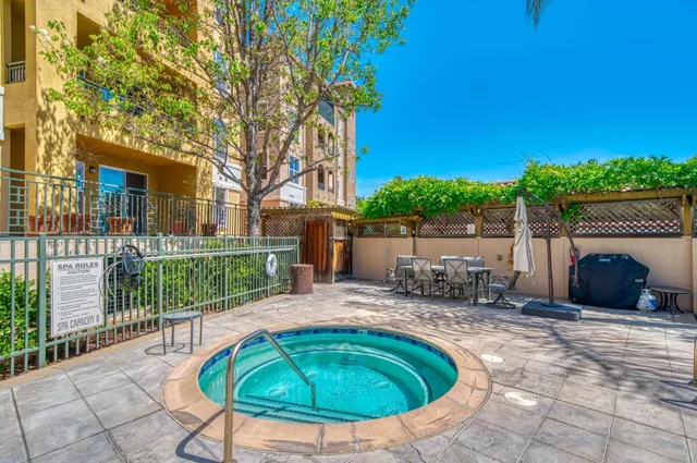 a swimming pool with outdoor seating yard and barbeque oven