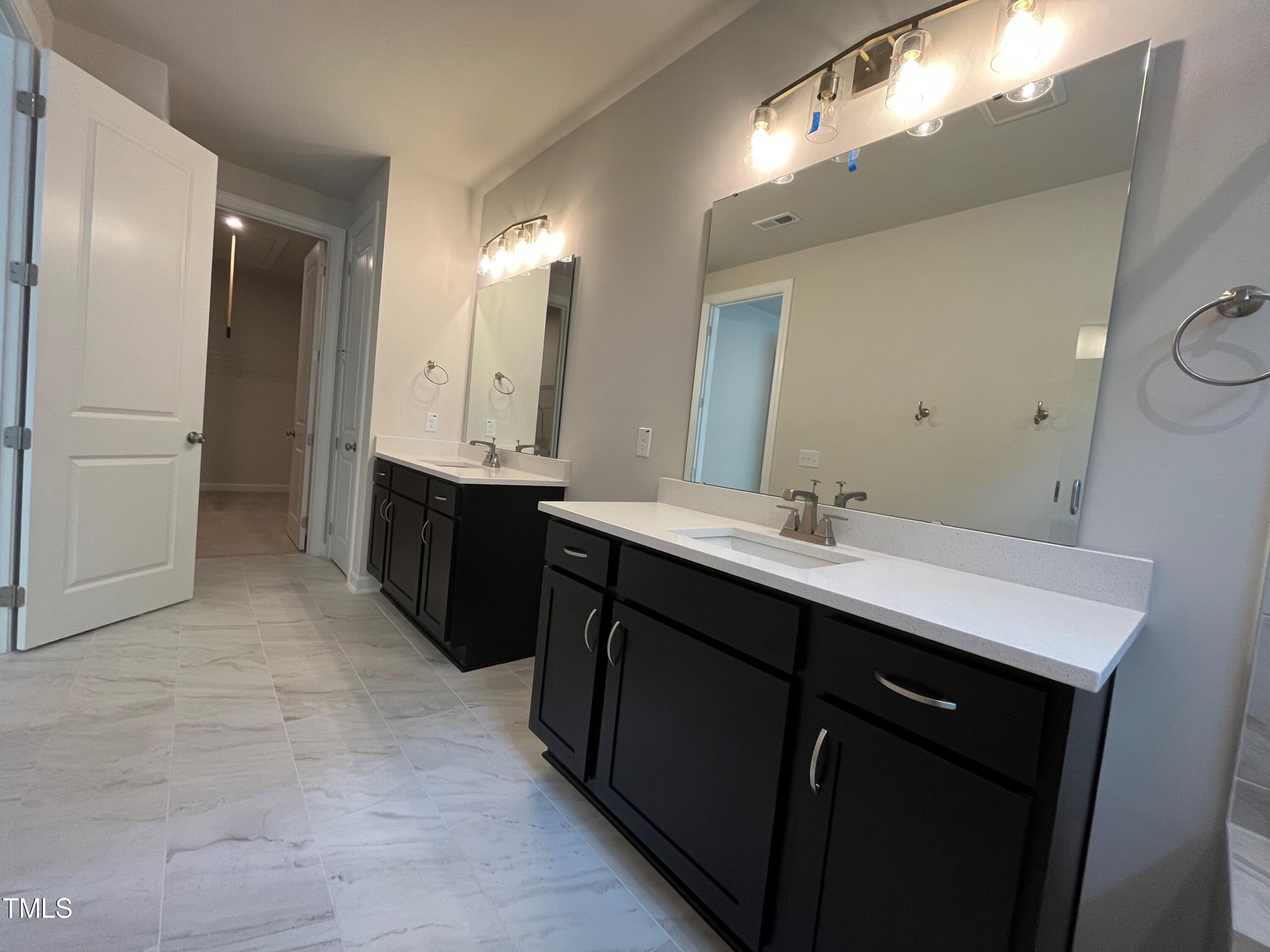 6102 Adecor Way Raleigh, NC 27617 - Photo 11 of 12 a bathroom with a double vanity sink and mirror