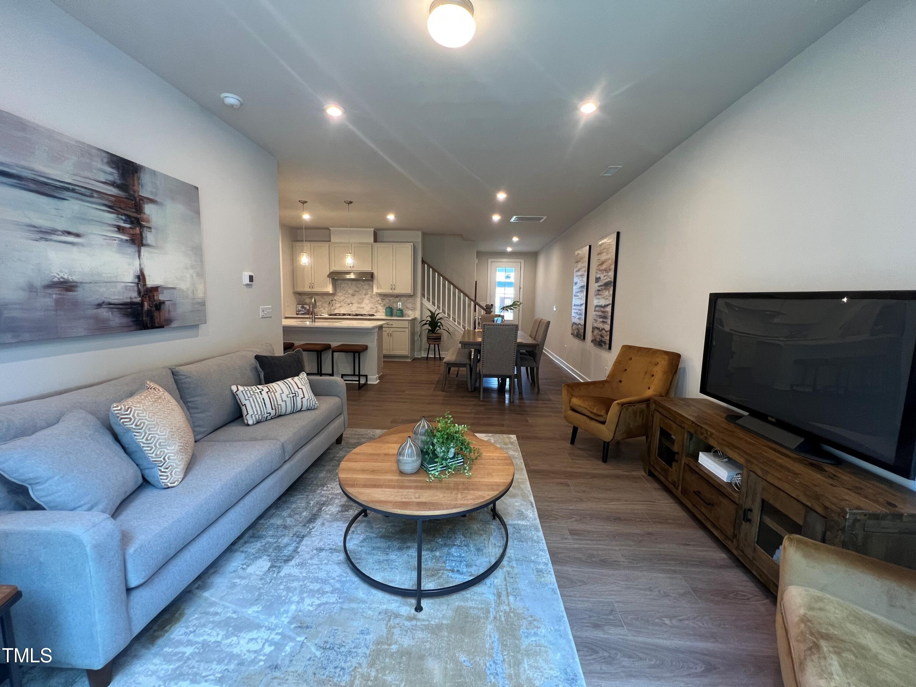 6102 Adecor Way Raleigh, NC 27617 - Photo 5 of 12 a living room with furniture and a flat screen tv