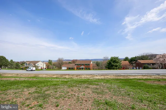 a view of field with tress in the background
