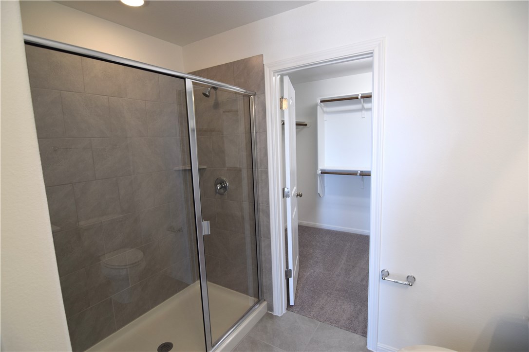 6705 Routenburn Street Austin, TX 78754 - Photo 10 of 18 a bathroom with a shower and a glass door