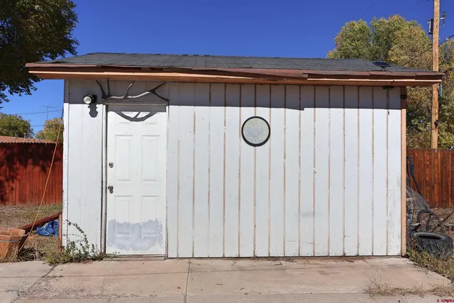 a view of a house with backyard space and wooden fence