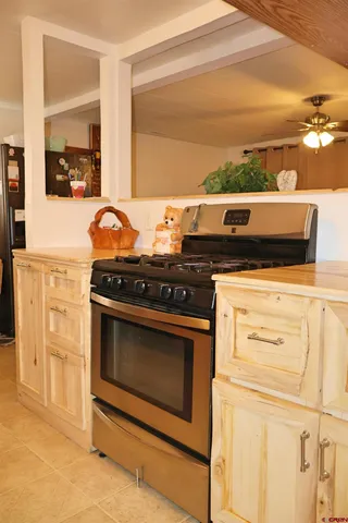 a kitchen with granite countertop a stove and a sink