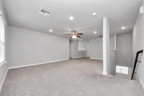 an empty room with a ceiling fan and a ceiling fan