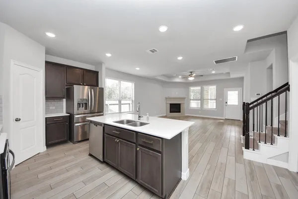 a kitchen with stainless steel appliances granite countertop a sink stove and refrigerator