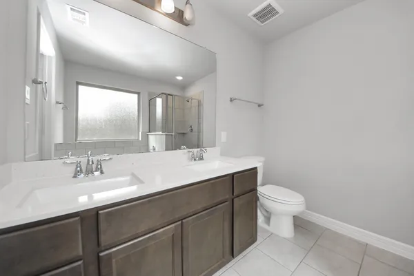 a bathroom with a sink toilet and mirror