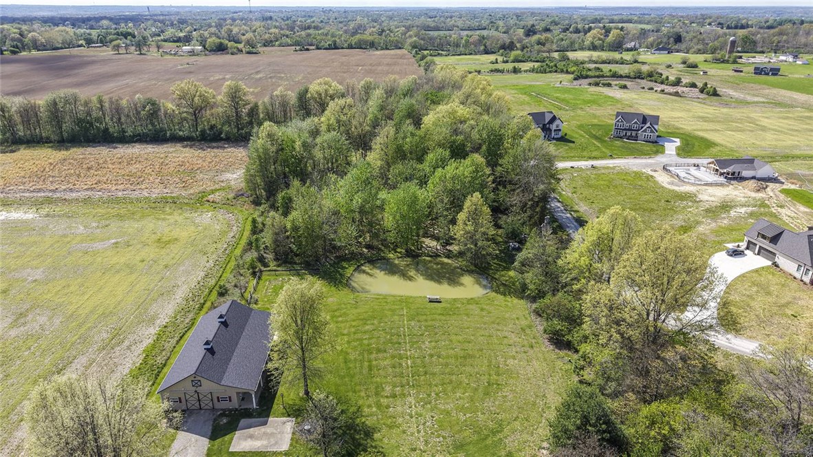 1757 Phillips Road Lebanon, OH 45036 - Photo 50 of 51 This aerial view showcases a vibrant landscape with a private pond and surrounding trees.