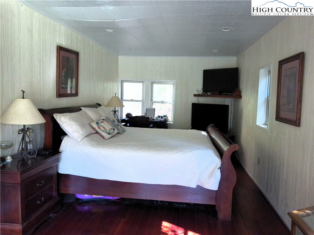 9752 Old Highway 16 Crumpler, NC 28617 - Photo 17 of 26 a bedroom with a bed and a flat screen tv