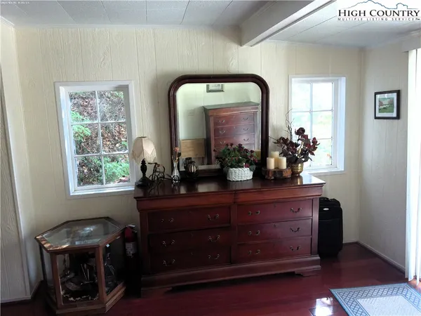 a room with a mirror and furniture