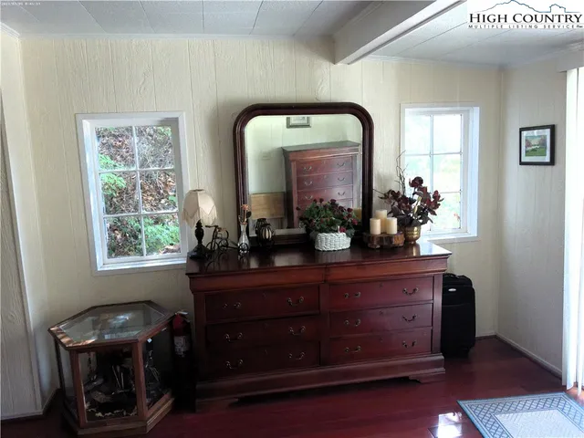 a room with a mirror and furniture