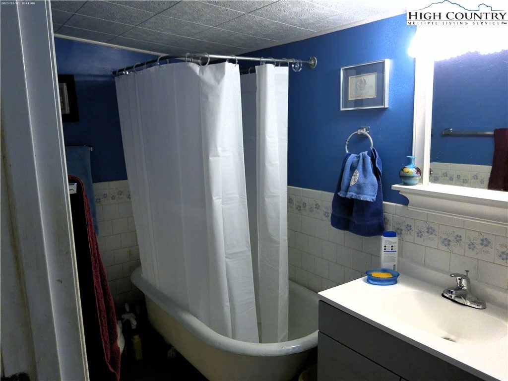 9752 Old Highway 16 Crumpler, NC 28617 - Photo 19 of 26 a bathroom with a sink a toilet and shower