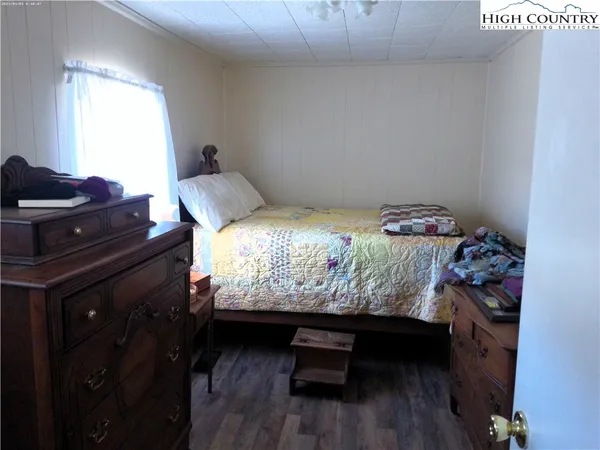 a bed sitting in a bedroom next to a window