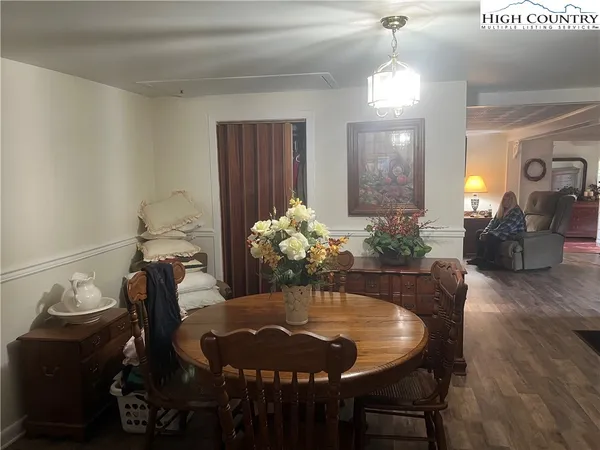 a dining room with furniture and wooden floor