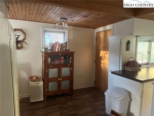 a view of a livingroom with furniture and a hallway
