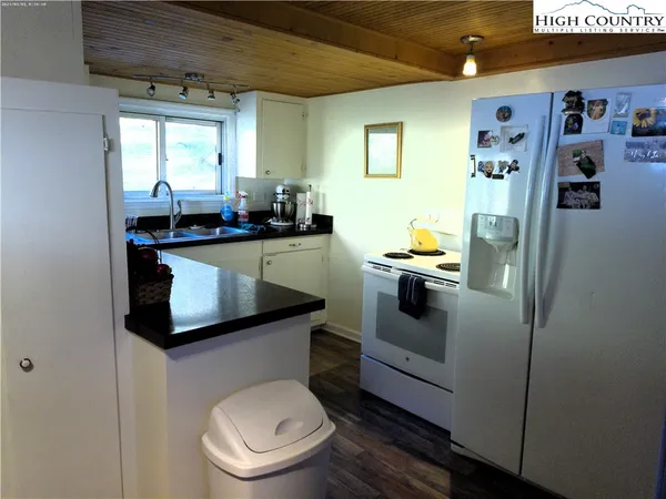 a kitchen with stainless steel appliances a refrigerator sink and stove