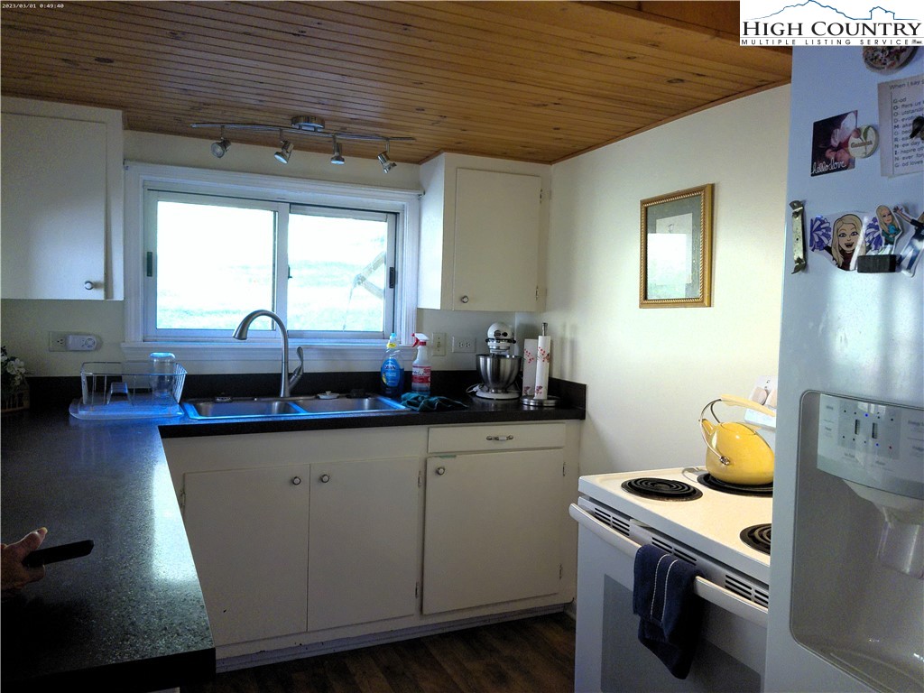 9752 Old Highway 16 Crumpler, NC 28617 - Photo 10 of 26 a kitchen with granite countertop a sink a stove and cabinets